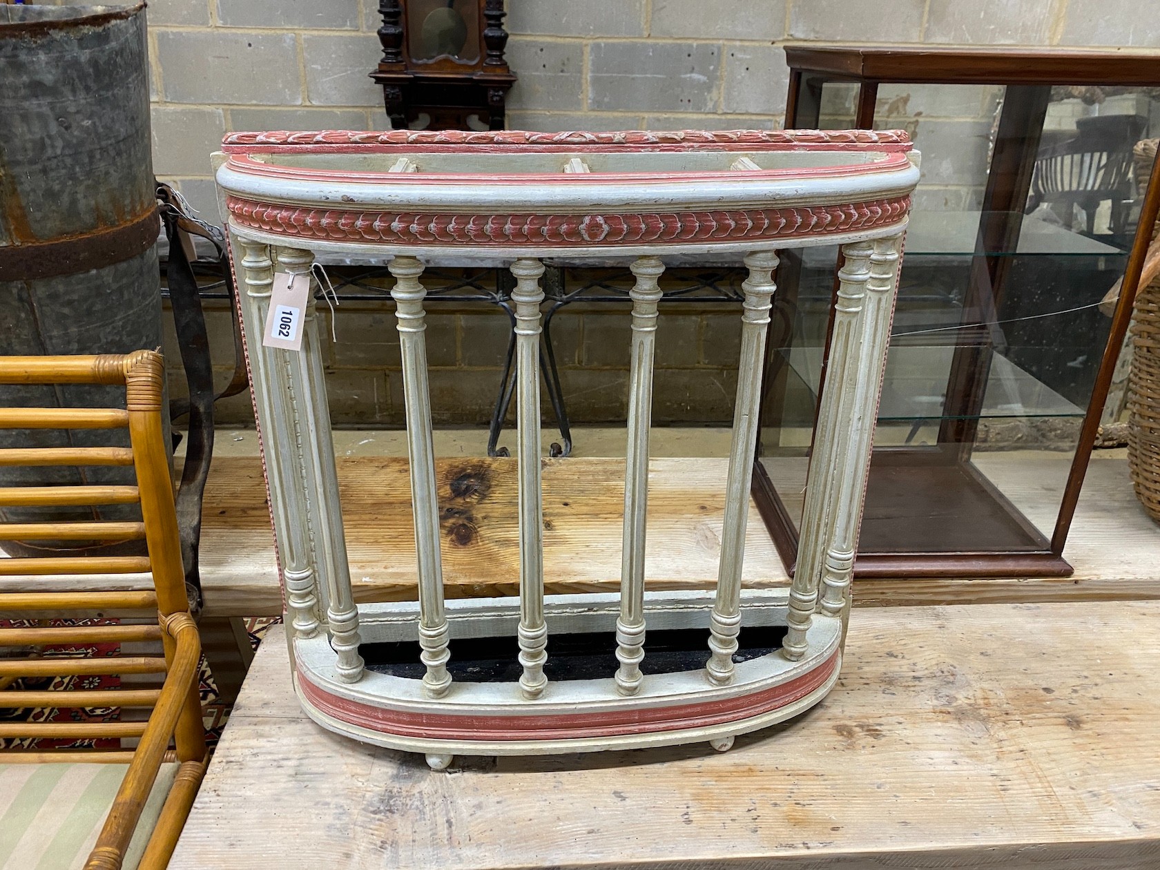 An early 20th century French painted four division stickstand with drip tray, width 73cm, depth 19cm, height 70cm